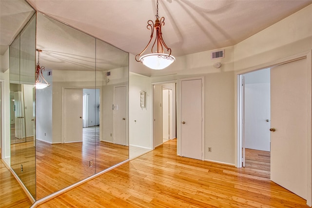 spare room with wood-type flooring