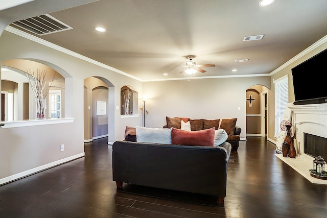 living room featuring dark hardwood / wood-style floors, ceiling fan, and ornamental molding