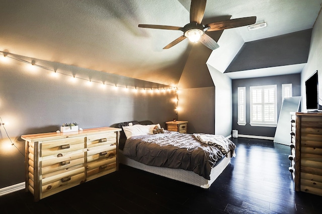 bedroom featuring a textured ceiling, ceiling fan, dark wood-type flooring, and vaulted ceiling