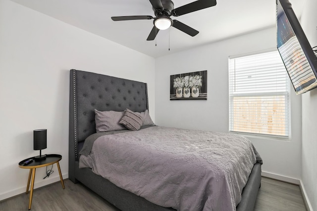 bedroom with hardwood / wood-style floors and ceiling fan