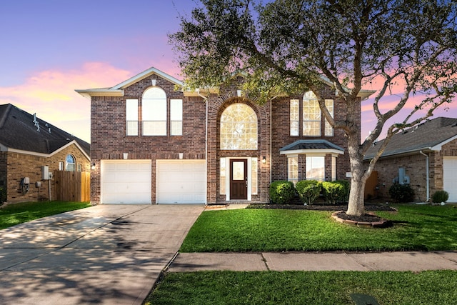 front facade with a garage and a yard