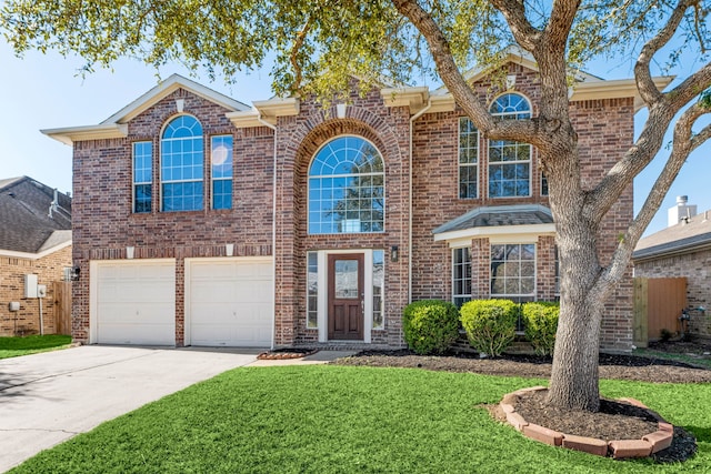 view of front of property with a front yard and a garage