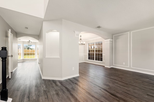 interior space featuring an inviting chandelier and dark wood-type flooring