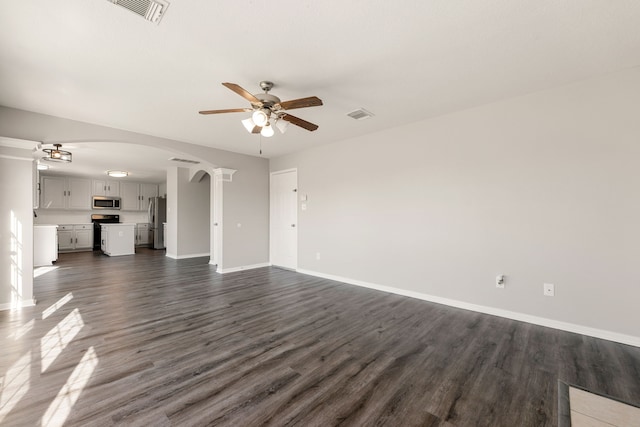 unfurnished living room featuring dark hardwood / wood-style floors and ceiling fan