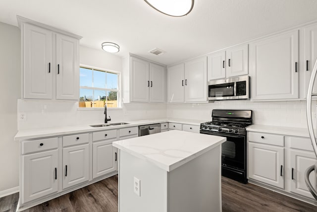 kitchen featuring white cabinetry, sink, dark wood-type flooring, a kitchen island, and appliances with stainless steel finishes