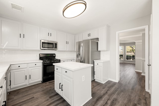 kitchen with dark hardwood / wood-style flooring, a center island, white cabinets, and stainless steel appliances