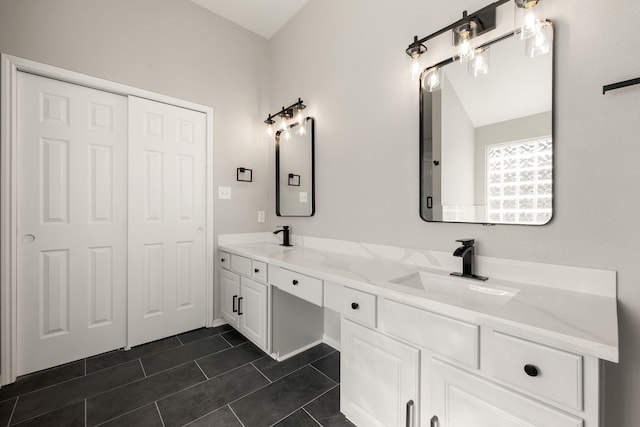 bathroom featuring tile patterned flooring, vanity, and lofted ceiling