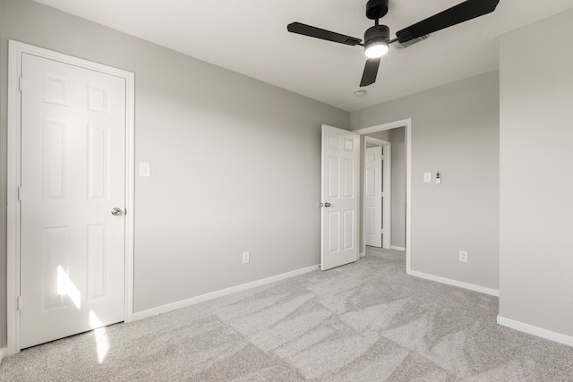 interior space with ceiling fan and light carpet