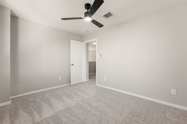 empty room with light colored carpet and ceiling fan