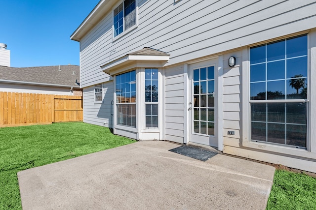 property entrance featuring a yard and a patio