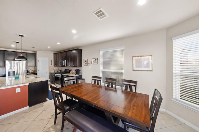 dining room featuring light tile patterned floors and sink