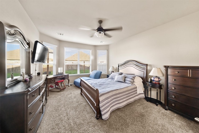 bedroom with ceiling fan and light colored carpet