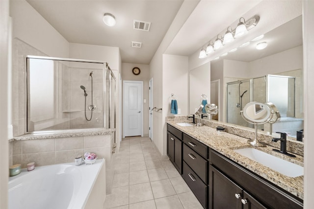 bathroom with plus walk in shower, vanity, and tile patterned floors