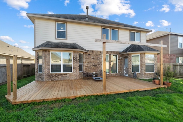 back of property featuring a lawn and a wooden deck