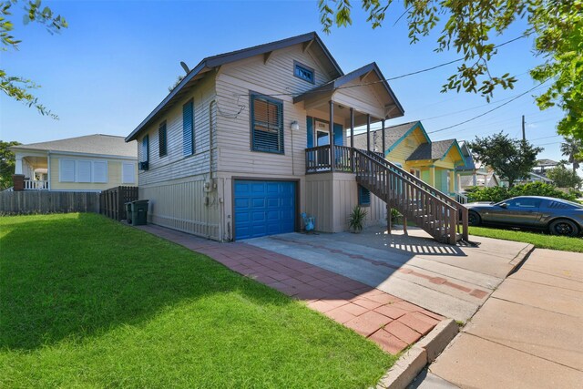 view of front of property featuring a garage and a front yard