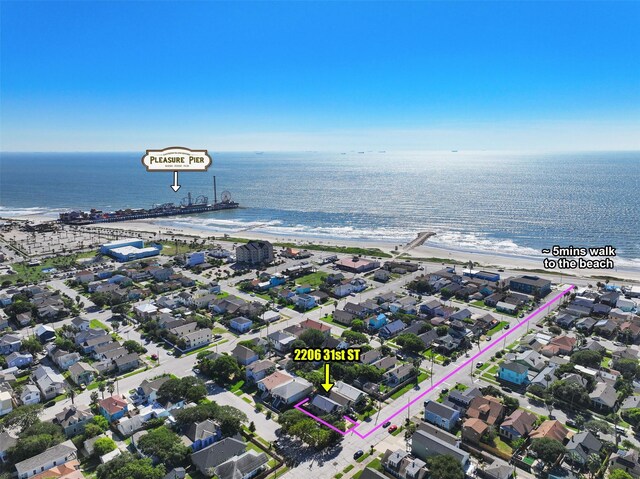 aerial view with a water view and a beach view