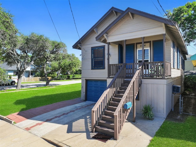 view of front facade featuring a porch, a garage, and a front yard