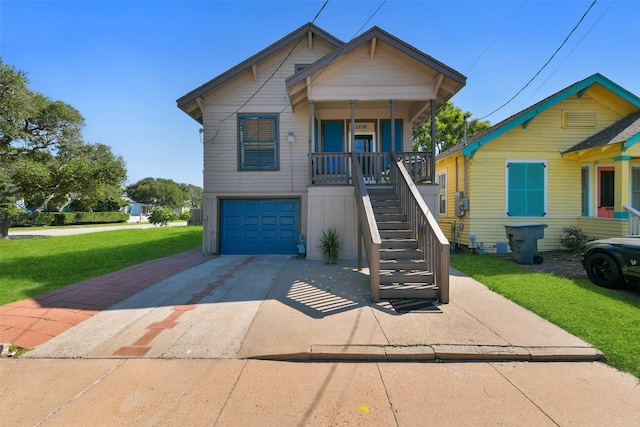 view of front of home with covered porch, a garage, and a front yard