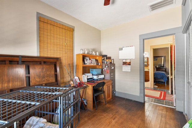 office space featuring dark wood-type flooring, visible vents, and baseboards