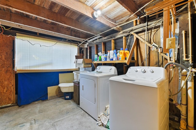 clothes washing area featuring laundry area and washer and clothes dryer