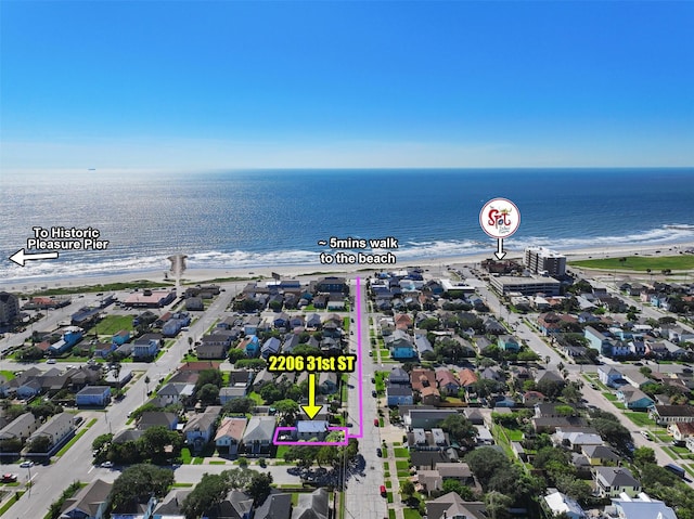 aerial view featuring a view of the beach and a water view