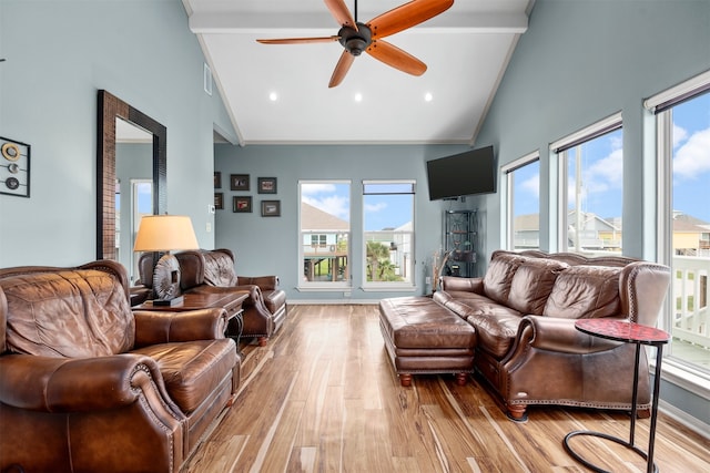 living room with a wealth of natural light, ceiling fan, high vaulted ceiling, and light wood-type flooring