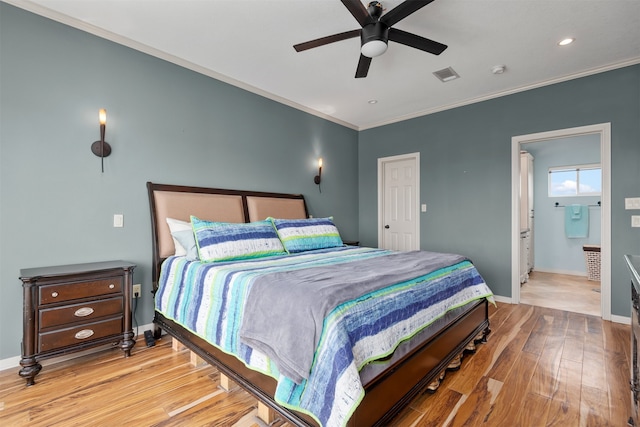 bedroom with ceiling fan, crown molding, light wood-type flooring, and ensuite bathroom