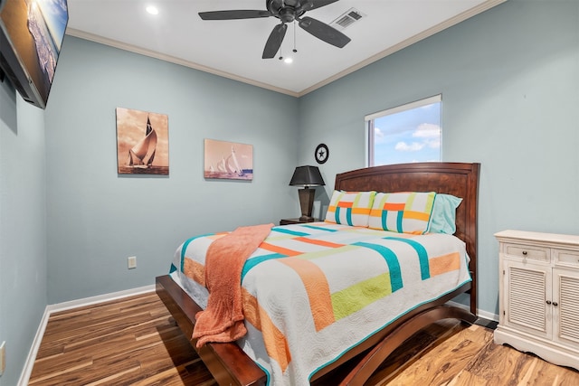 bedroom with ceiling fan, dark hardwood / wood-style flooring, and ornamental molding