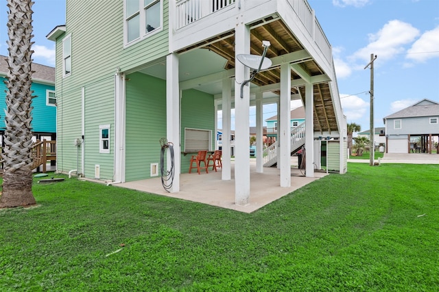 rear view of property with a yard and a patio