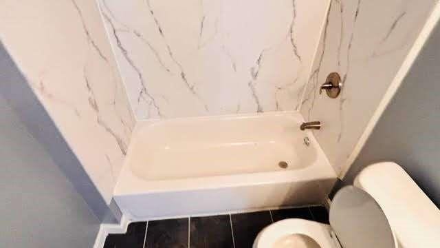 bathroom with tile patterned flooring and toilet