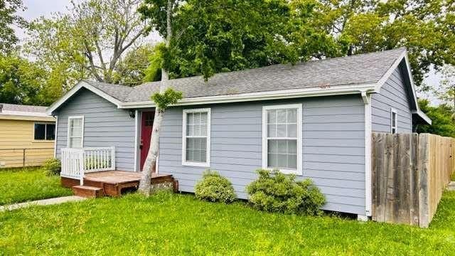 rear view of property featuring a lawn