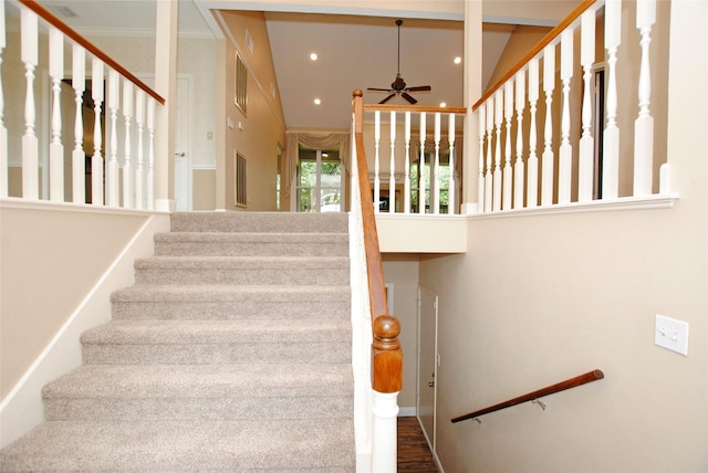 stairway featuring crown molding, hardwood / wood-style flooring, and ceiling fan