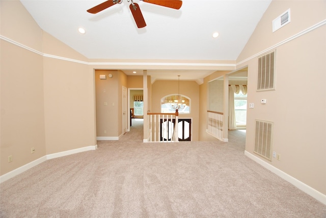 unfurnished room featuring lofted ceiling, light colored carpet, and an inviting chandelier