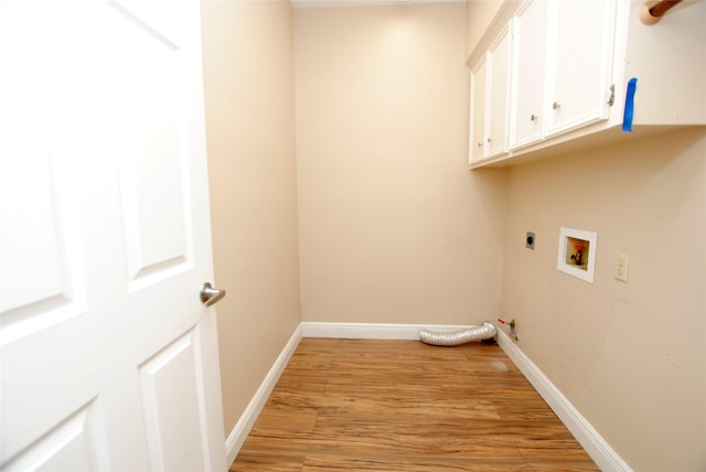 washroom with washer hookup, cabinets, light hardwood / wood-style floors, and hookup for an electric dryer