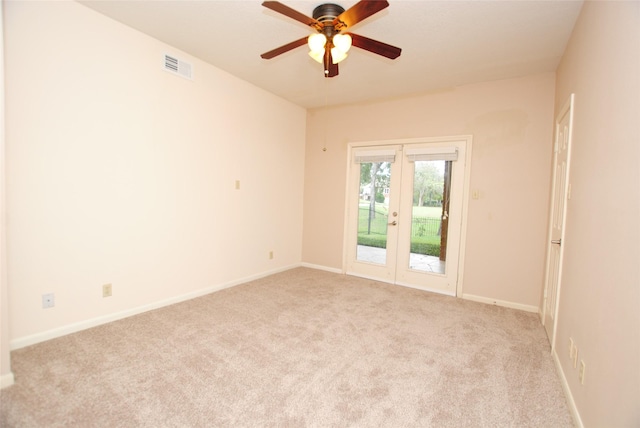 carpeted spare room with french doors and ceiling fan