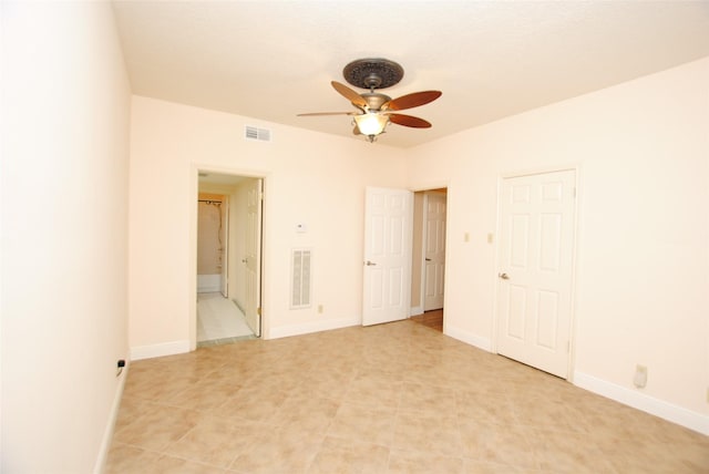 unfurnished bedroom with ceiling fan and ensuite bath