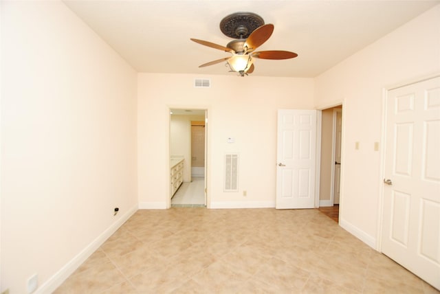 unfurnished bedroom with ensuite bathroom and ceiling fan