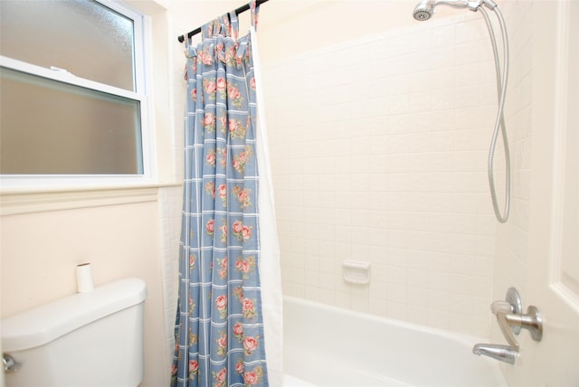 bathroom featuring toilet and shower / tub combo