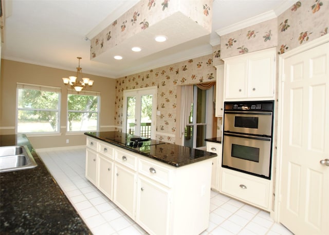 kitchen featuring white cabinetry, double oven, black electric cooktop, and a kitchen island