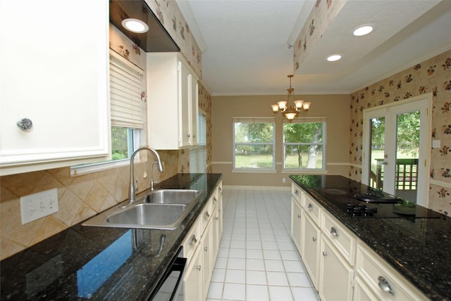 kitchen featuring sink, white cabinetry, crown molding, decorative light fixtures, and light tile patterned floors