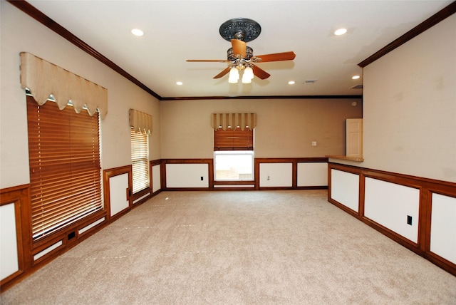 carpeted empty room featuring crown molding and ceiling fan