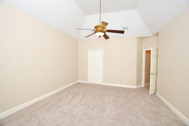 carpeted empty room featuring vaulted ceiling and ceiling fan