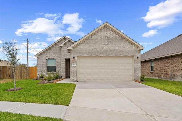 view of front of home featuring a garage and a front lawn