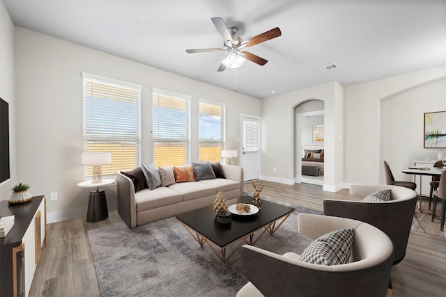 living room with hardwood / wood-style flooring and ceiling fan