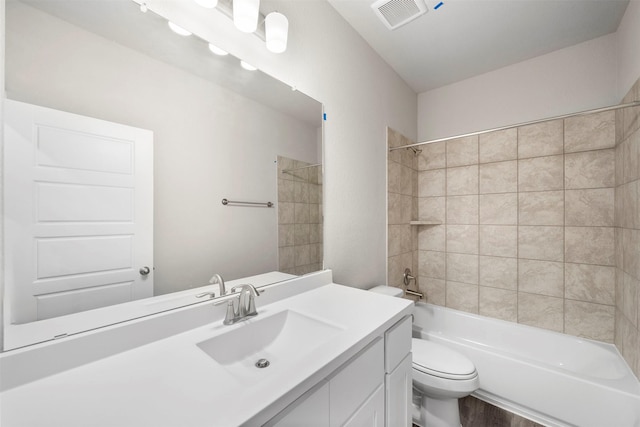 full bathroom featuring vanity, toilet, and tiled shower / bath