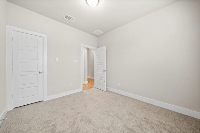 unfurnished bedroom with light colored carpet