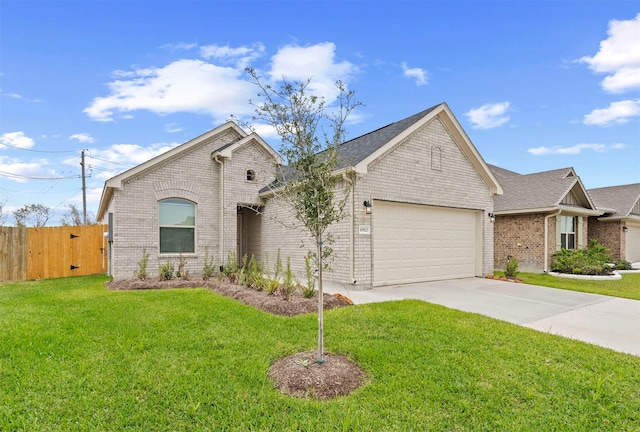 view of front of home with a garage and a front lawn