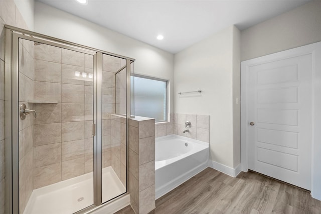 bathroom featuring hardwood / wood-style floors and plus walk in shower