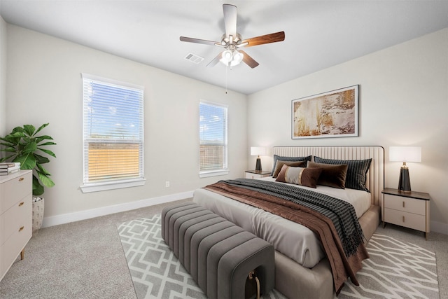 bedroom with ceiling fan and light colored carpet