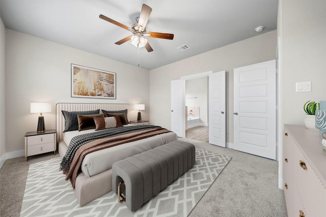 bedroom featuring ensuite bath, ceiling fan, and light colored carpet